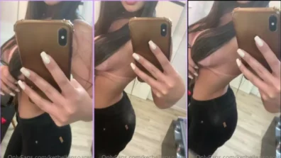 Kethellen Soares filmando no espelho sua roupa decotada