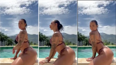 Jennifer Sánchez na beira da piscina balançando o popozão
